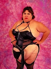 Dominatrix Looking Fat Chick Posing with Whip